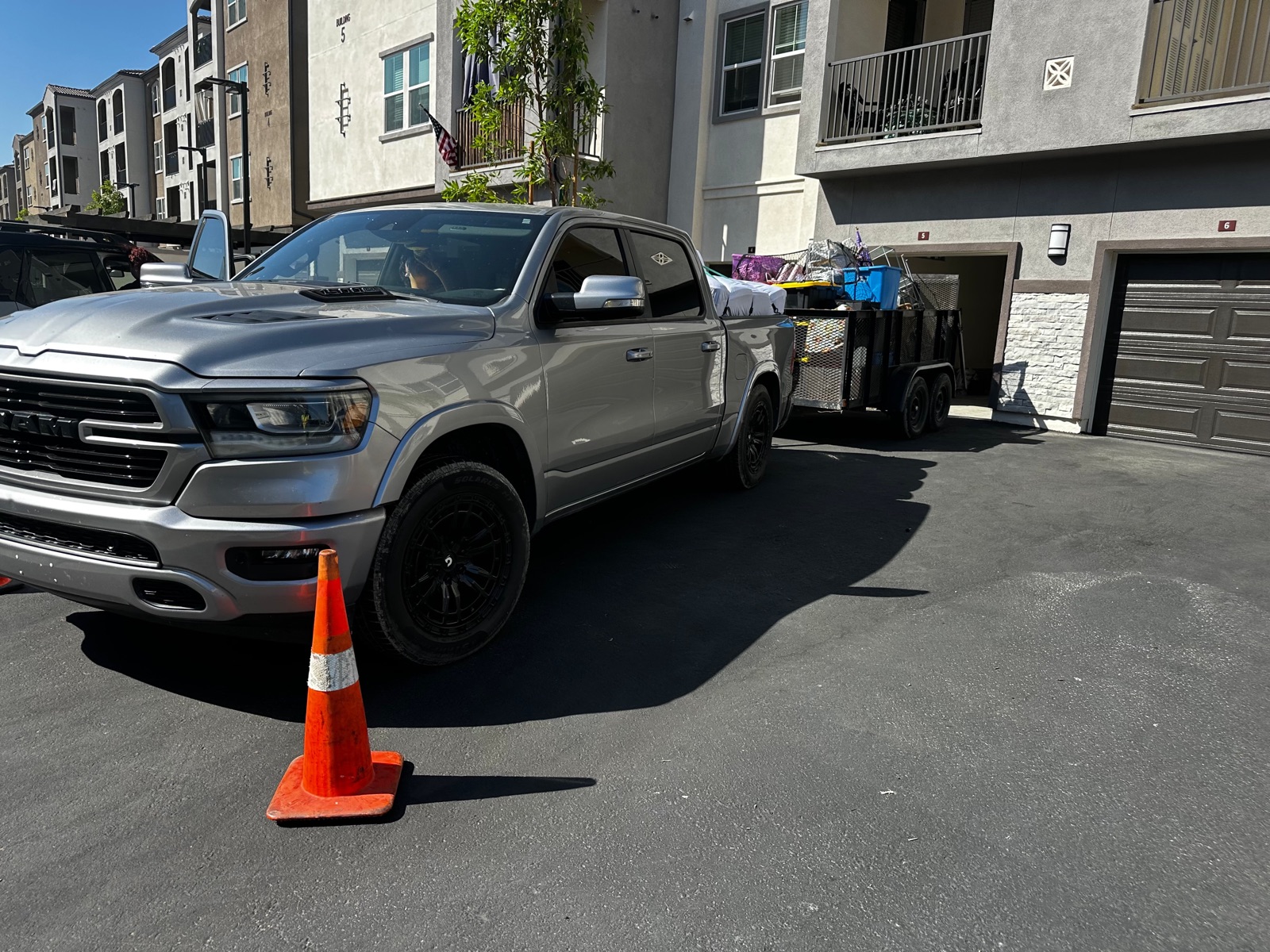 Royce truck and trailer loaded with the hauled-away household junk